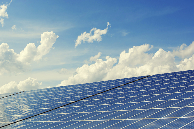 Photo of clouds in the sky above solar panels