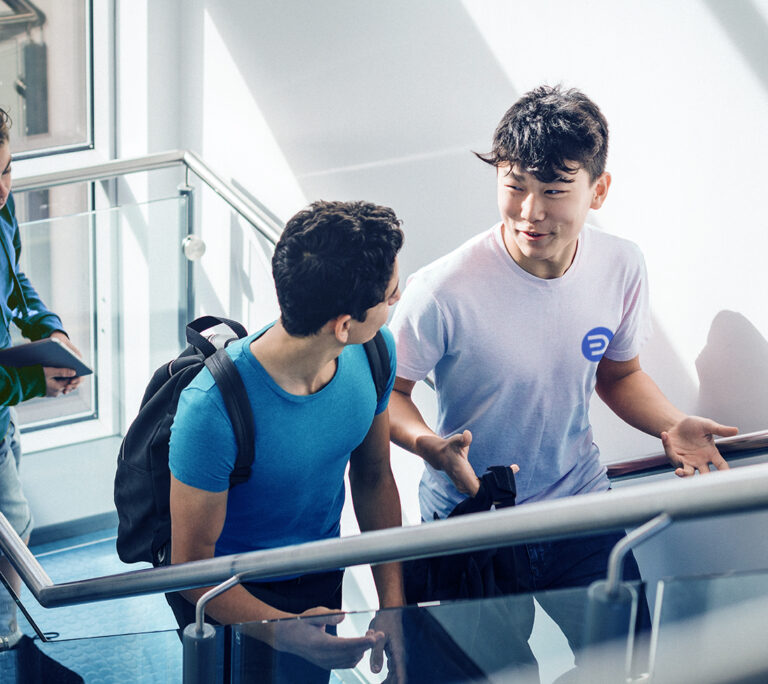 Photo of two young men walking up a stairs