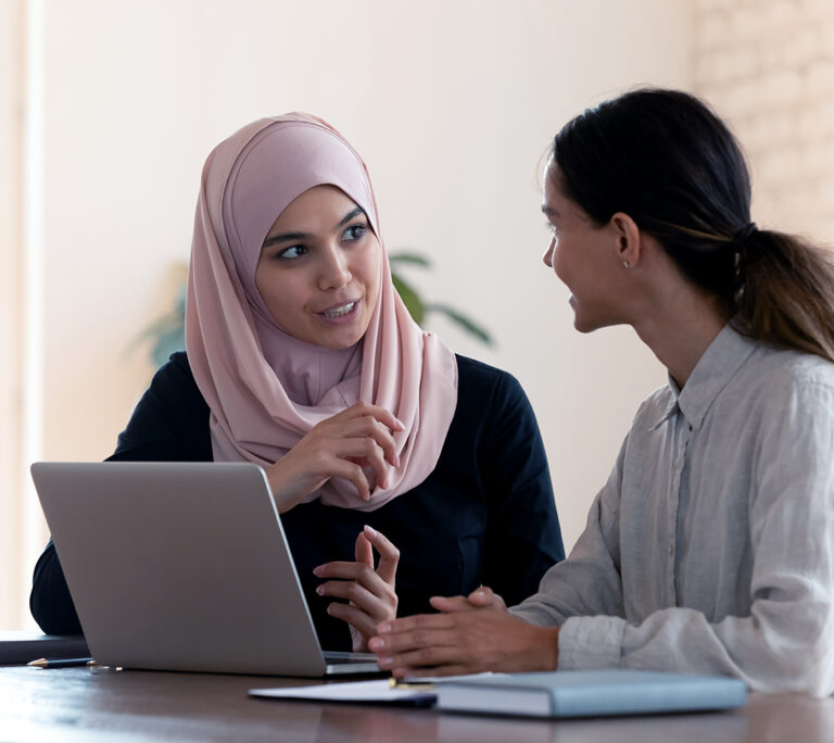Two women working together