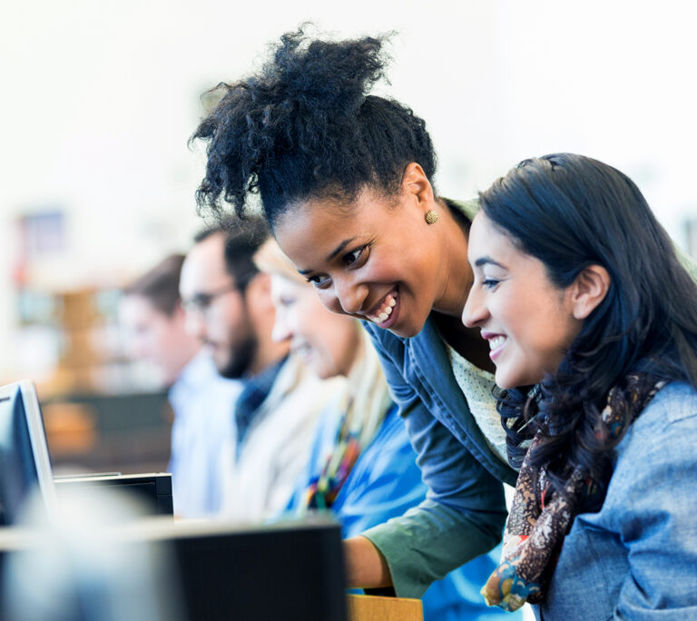 Diverse colleagues working together on computers
